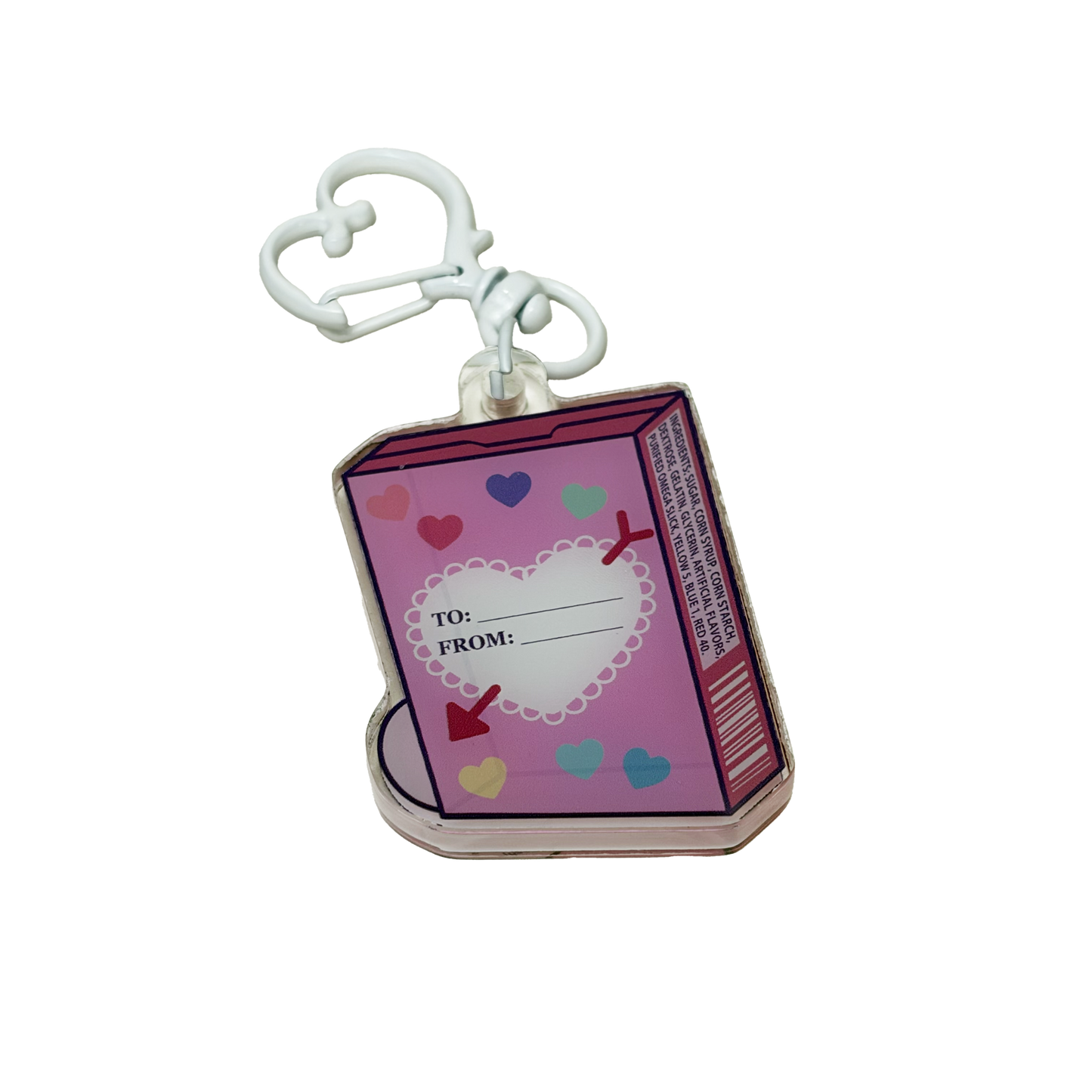 The back side of an acrylic shaker keychain shaped like a box of candy hearts including a to and from field and an ingredients list.