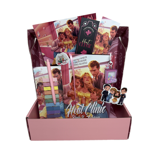 The Heat Clinic Special Edition book box items are shown spilling out of a pink mailing box. The book box includes the hardcover, an annotation tab and pen set, 2 vinyl stickers, 2 art prints, 2 matching bookmarks, and an acrylic shaker keychain.